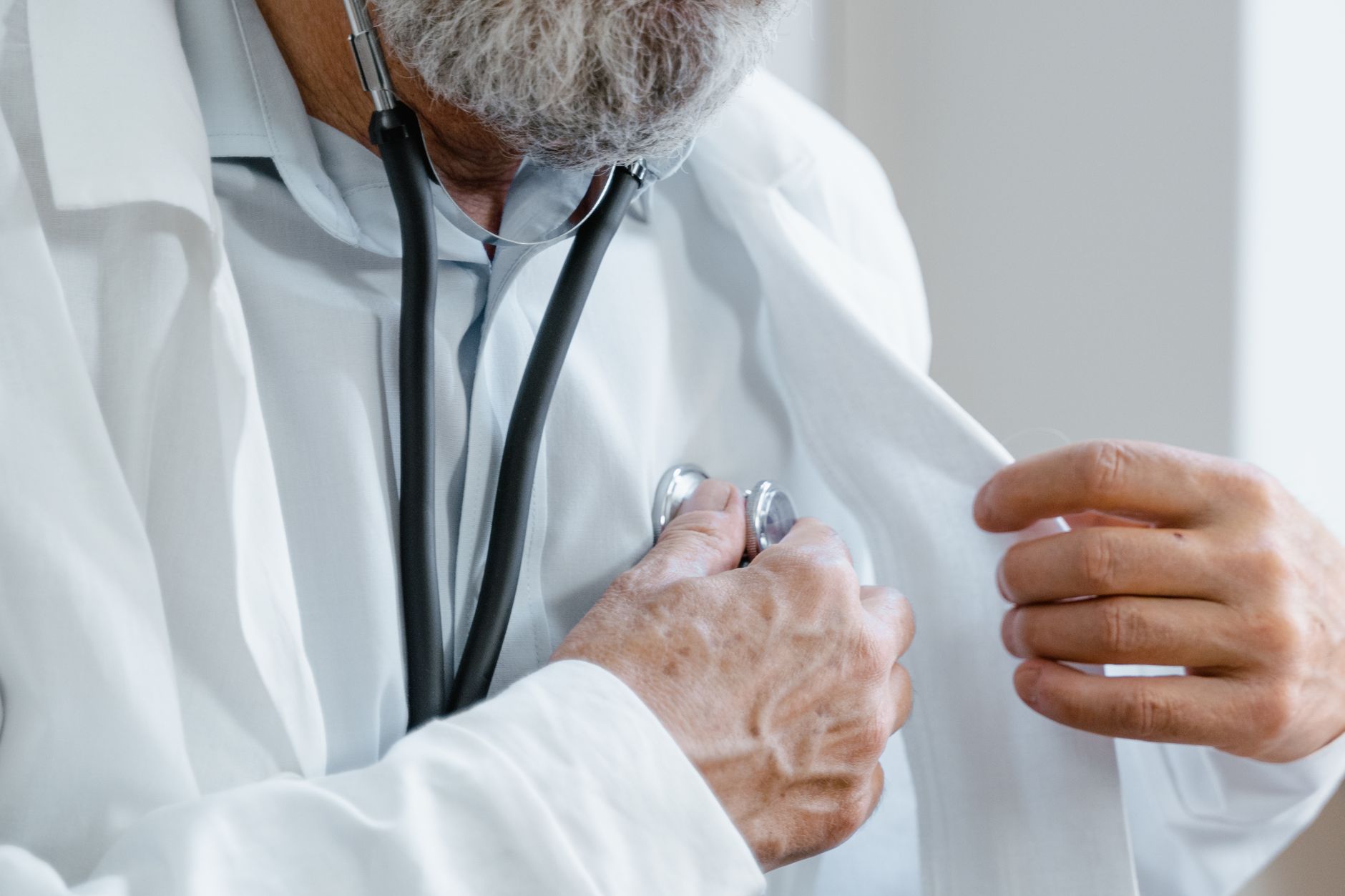 Close-up of a doctor adjusting a stethoscope while in a medical consultation. — 10 Things to Consider Before Getting a Mommy