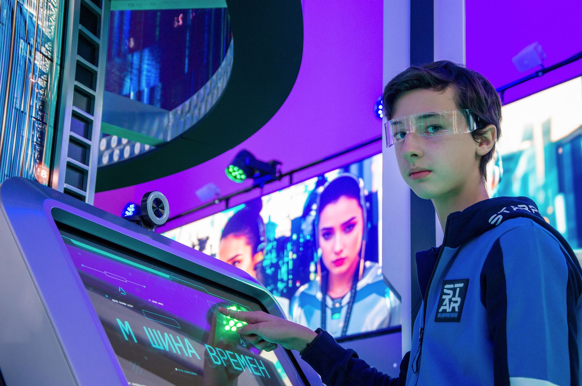 Teen boy in a digital room interacting with a futuristic touchscreen device wearing protective goggles. — Best PC Cleaner Sof