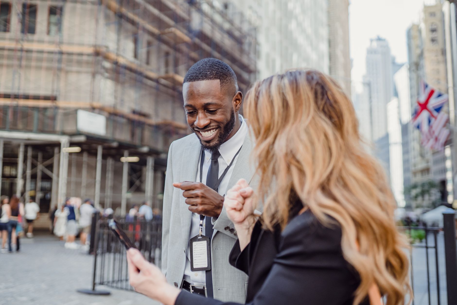Two business professionals engage in lively conversation on an urban street, sharing insights. — Buy The Perfect Gift Card: A