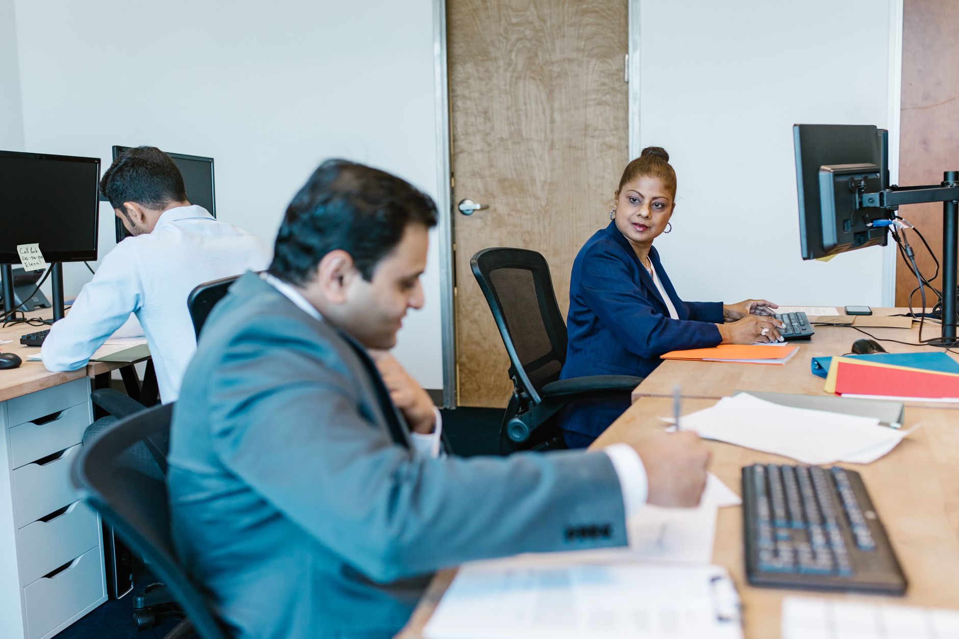 Diverse professionals collaborating in modern office setting, fostering teamwork. — Cryptocurrencies - Trade Leading Digital