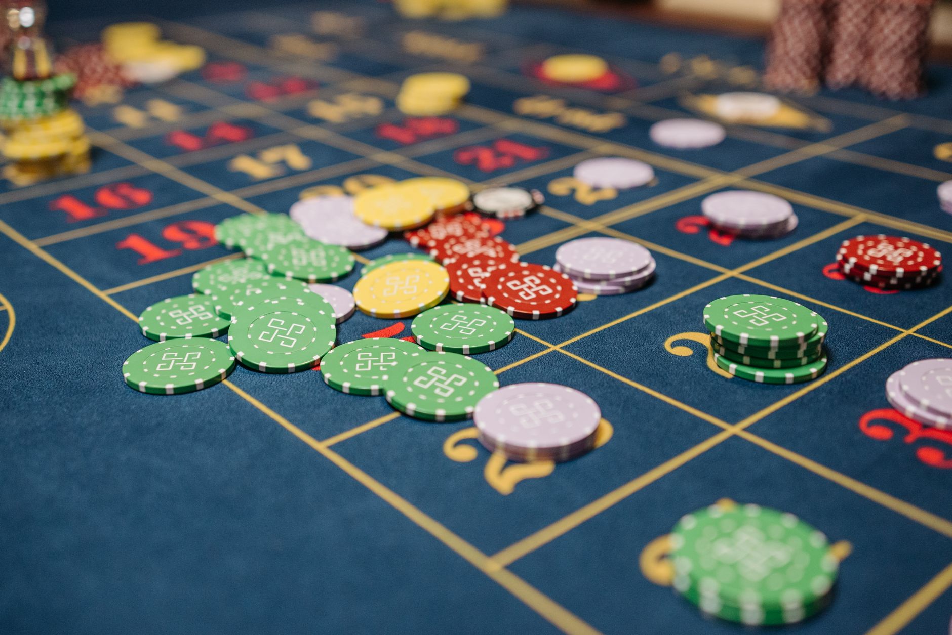 Closeup of colorful casino chips scattered on a roulette table. — Get acquainted with About Ufabet369