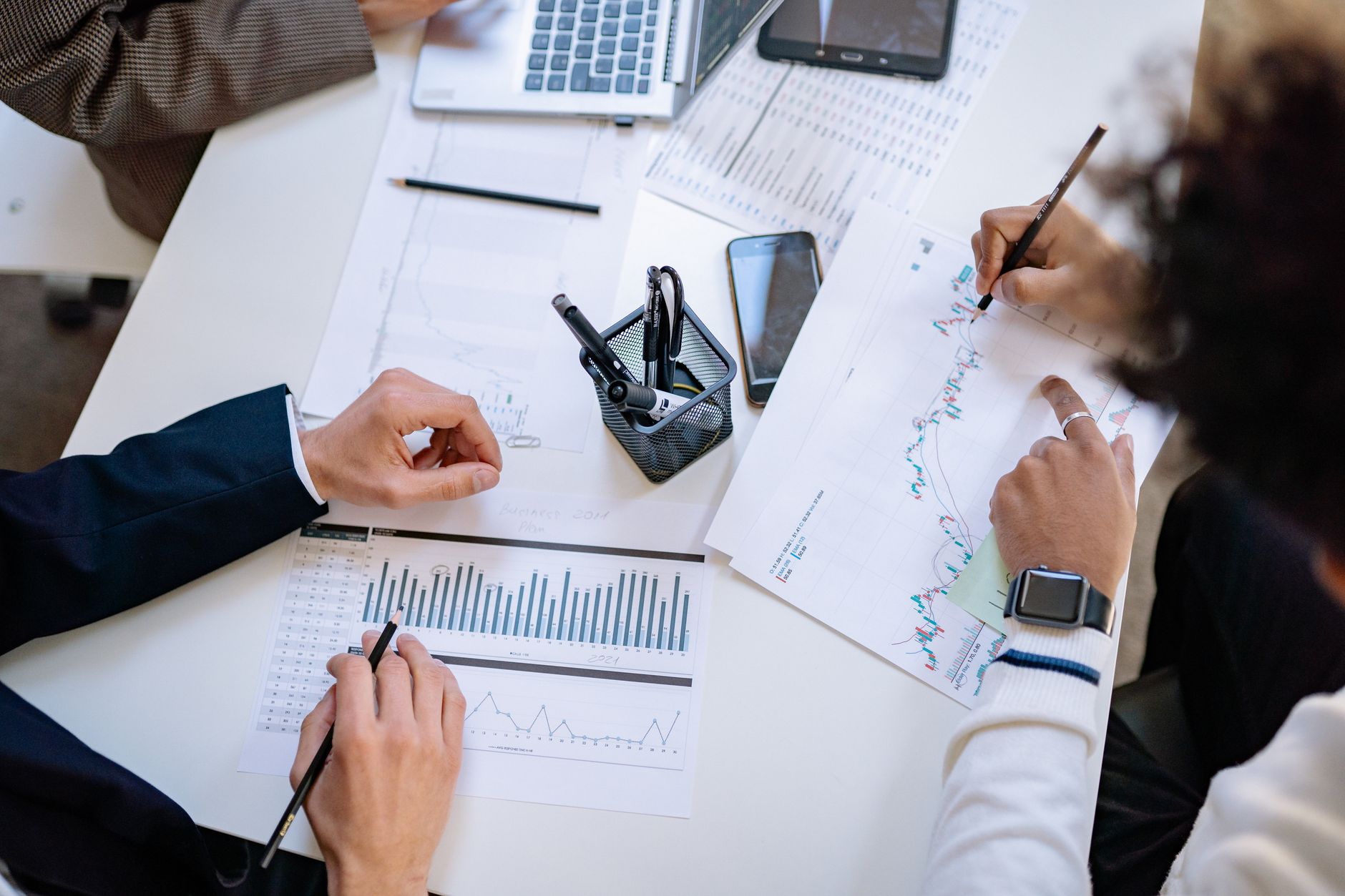 Business team analyzing financial charts and graphs during a collaborative meeting. — How an HHA Certification Can Benefit Yo