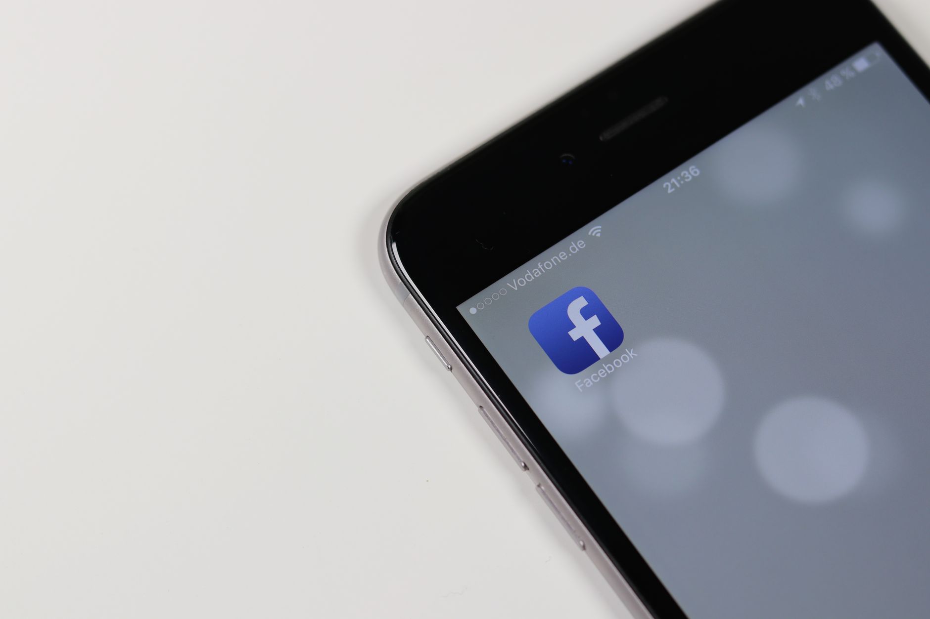 IPhone displaying Facebook app icon with blurred background, emphasizing social media connectivity. — How Much Do Likes and F
