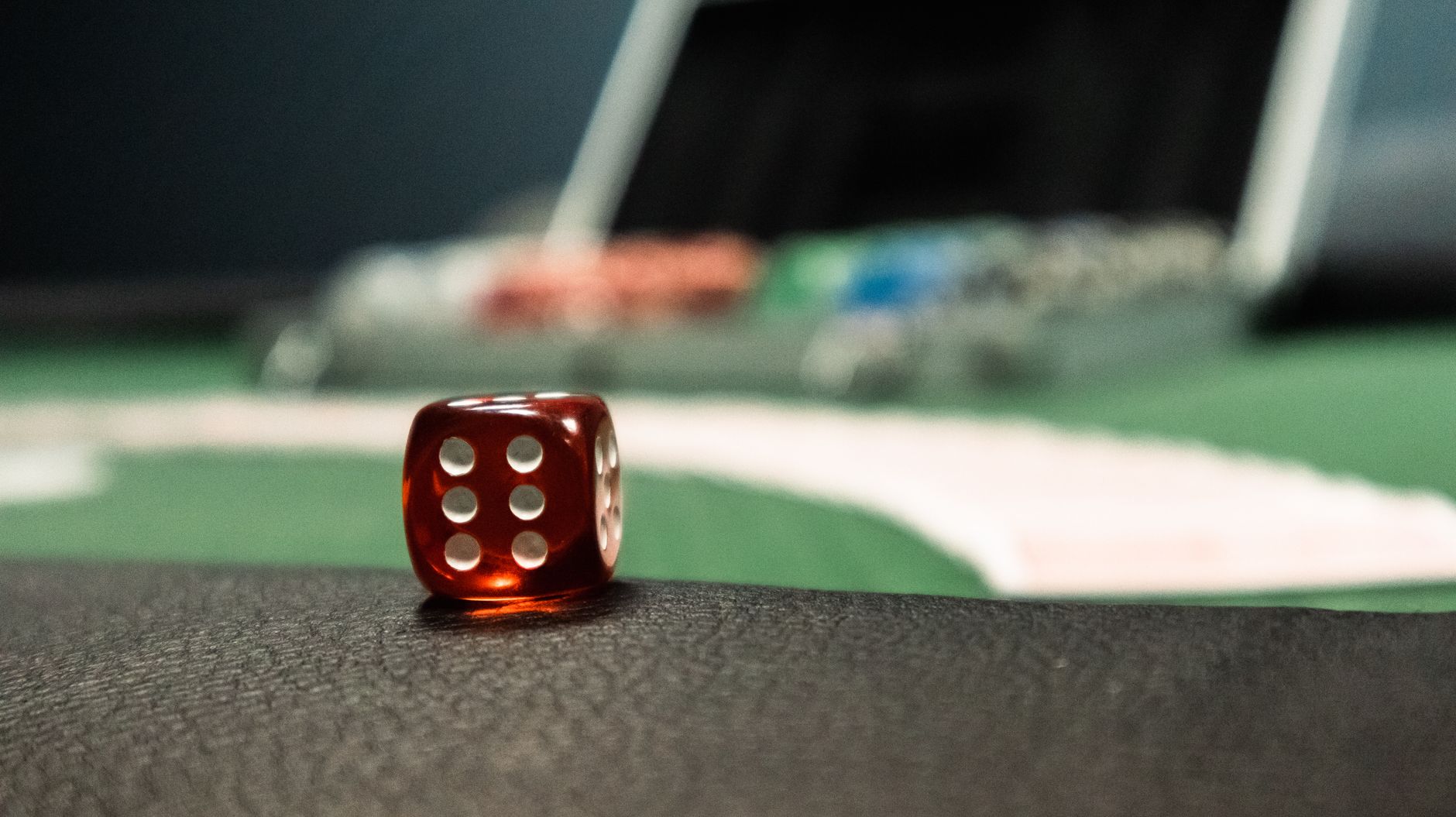 A close-up of a red dice on a casino table, evoking a sense of gambling excitement. — How To Bet On Sports Like A Pro With UF