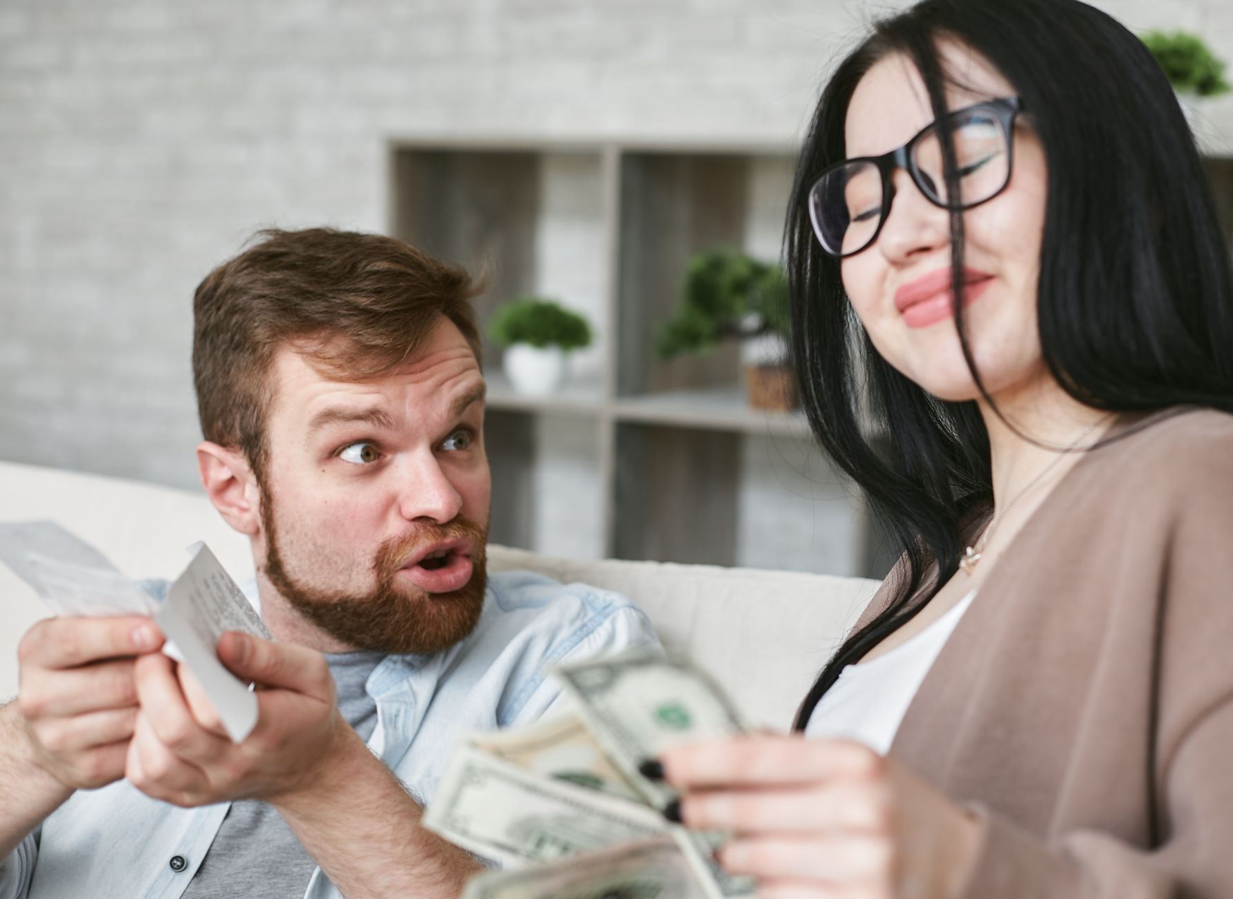 Interracial couple arguing over bills and cash at home. — Universal Gift Card And Its Benefits