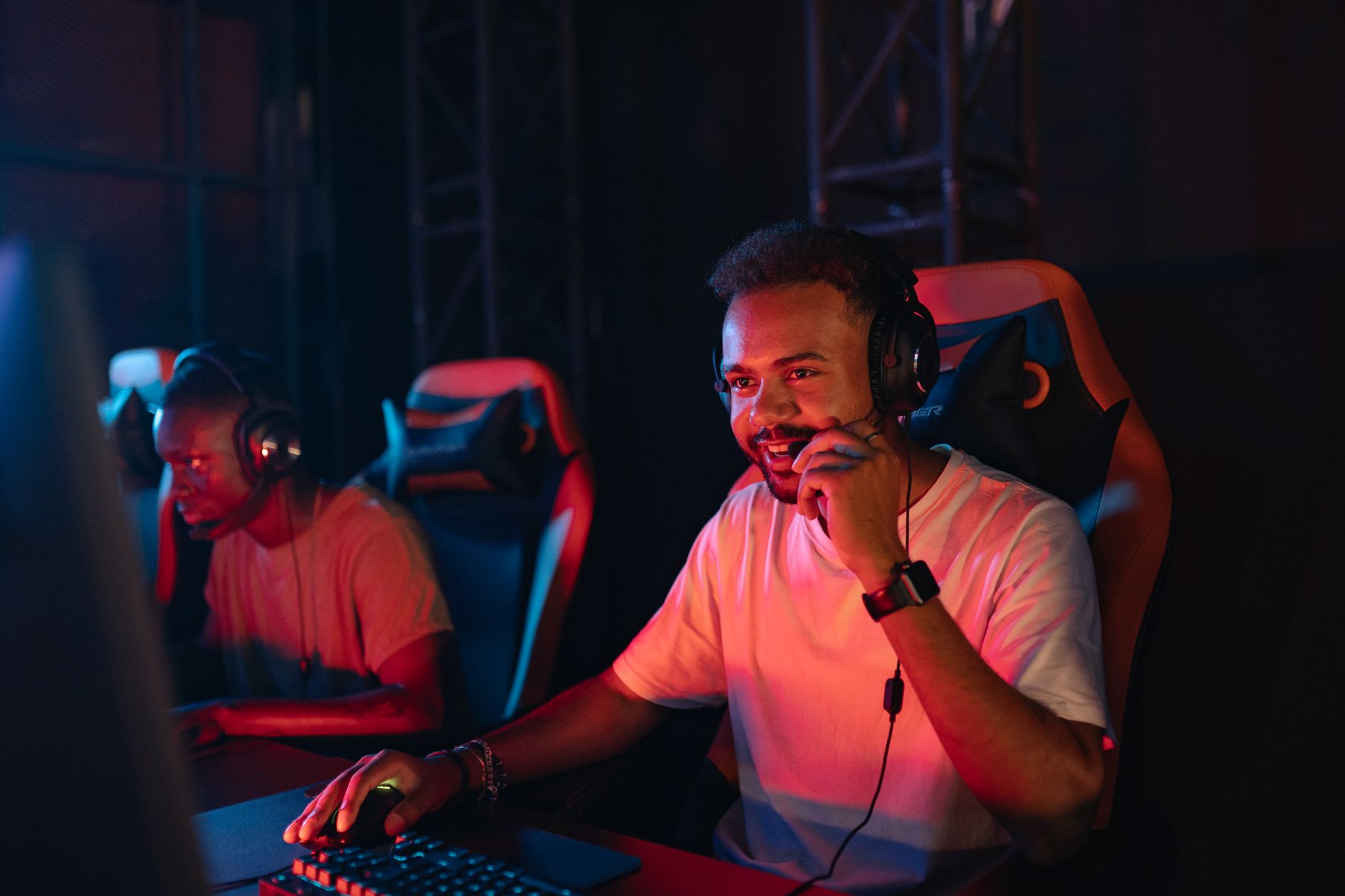Two gamers immersed in an esports tournament, focused with headsets and keyboards. — Why On the web baccarat is the Best Acti