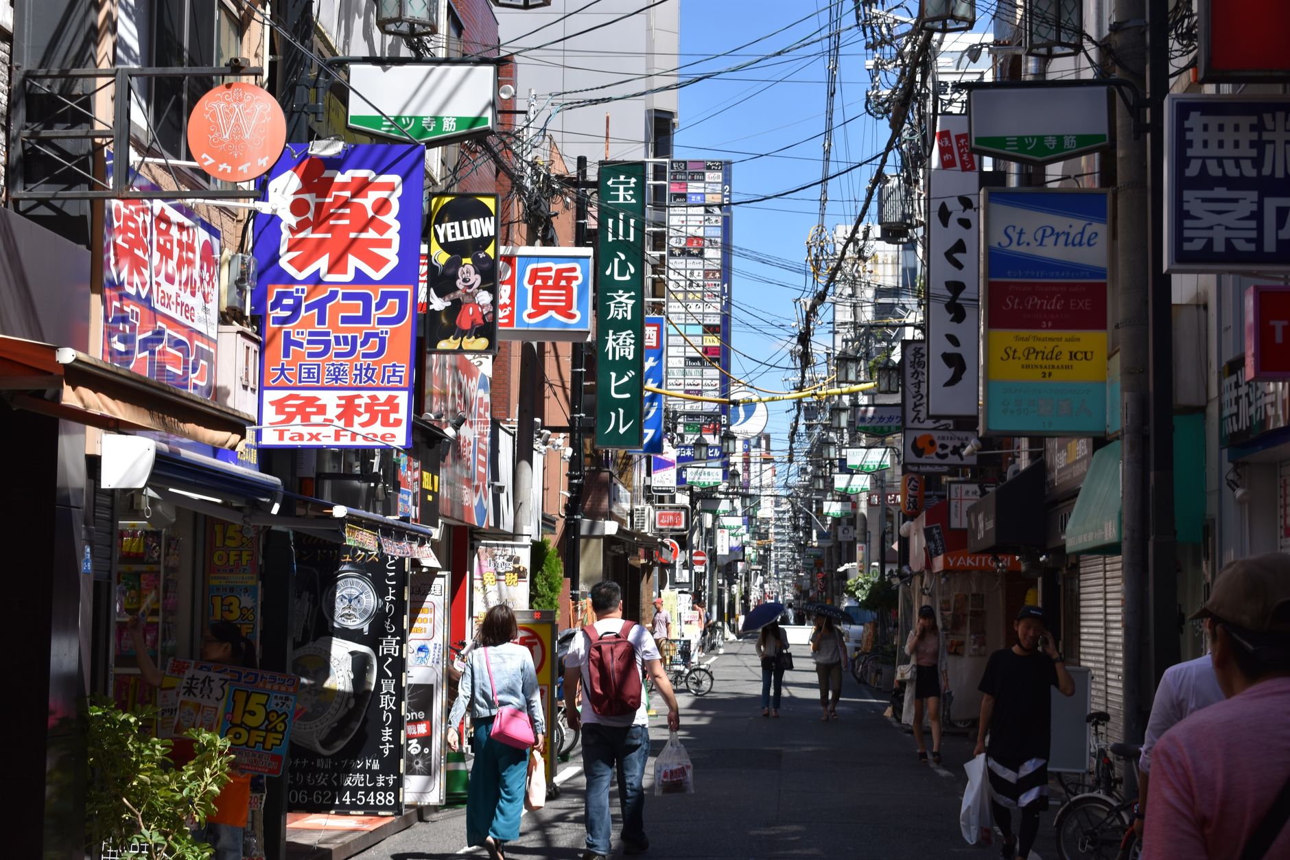 Bustling urban street in Osaka with colorful advertisements and pedestrians in daylight. — Why You Should Consider seo compan